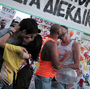 Couples kiss during the Athens gay pride parade last June. Last month, activists organized a kiss-in during a church service run by a Greek Orthodox bishop who has threatened to excommunicate politicians supporting same-sex unions.