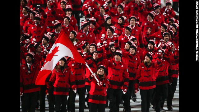 The Canadians, led by hockey player Hayley Wickenheiser, enter the stadium.