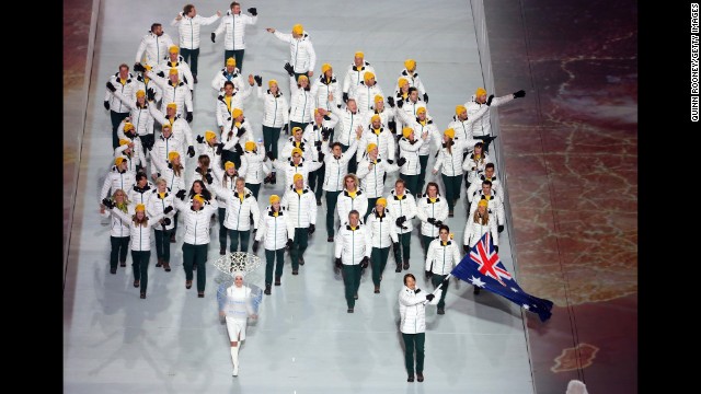 Snowboarder Alex Pullin of the Australian Olympic team carries his country's flag during the opening ceremony.