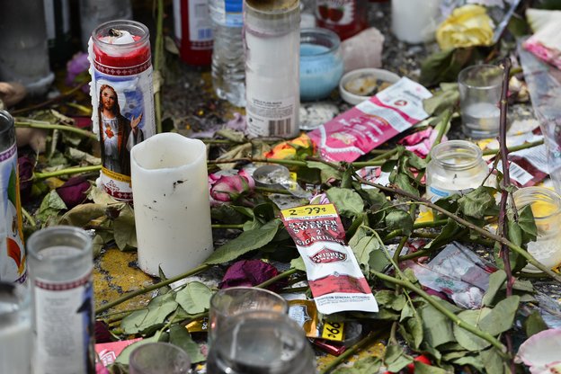 A memorial sits at the site of Michael Brown's death in Ferguson, Mo. Any investigation into his shooting by a police officer is likely to take months.