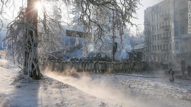 Riot police officers stand in line during anti-government protests in Kiev on Saturday, January 25.