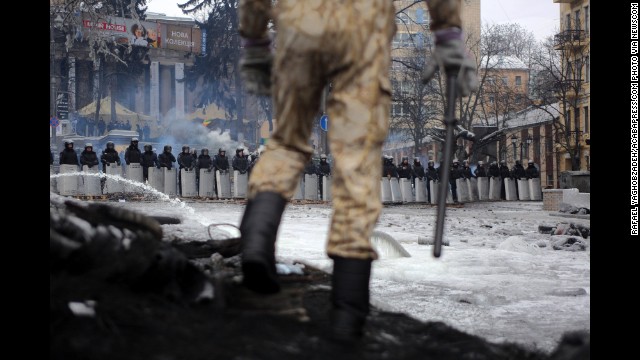 A protester stands on top of barricades in Kiev on Tuesday, January 28.