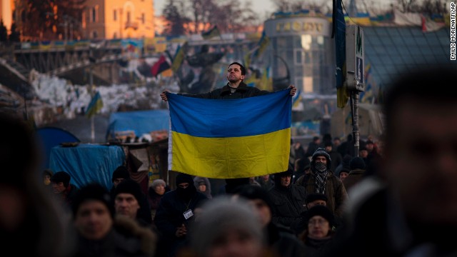 A protester holds a Ukrainian flag in Independence Square on Tuesday, February 4.