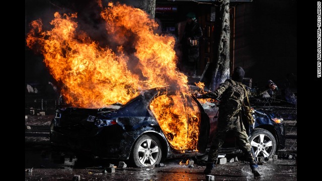 Protesters burn a car in central Kiev on February 18.