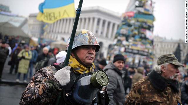 A Maidan self-defense unit member stands in support of Ukraine in Independence Square in Kiev, Ukraine, on March 2. Ukraine's shaky new government mobilized troops and called up military reservists Sunday amid signs of Russian military intervention in Ukraine's Crimean peninsula, even as the defense minister said Kiev stood no chance against Russian troops in a rapidly escalating crisis that has raised fears of a conflict.