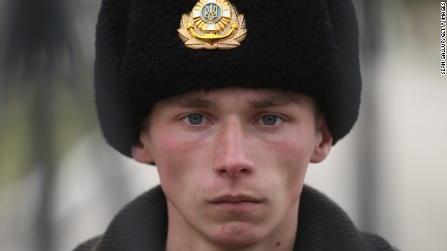 A young Ukrainian soldier stands behind the gate inside a Ukrainian military base that was surrounded by several hundred Russian-speaking soldiers in Crimea on March 2.