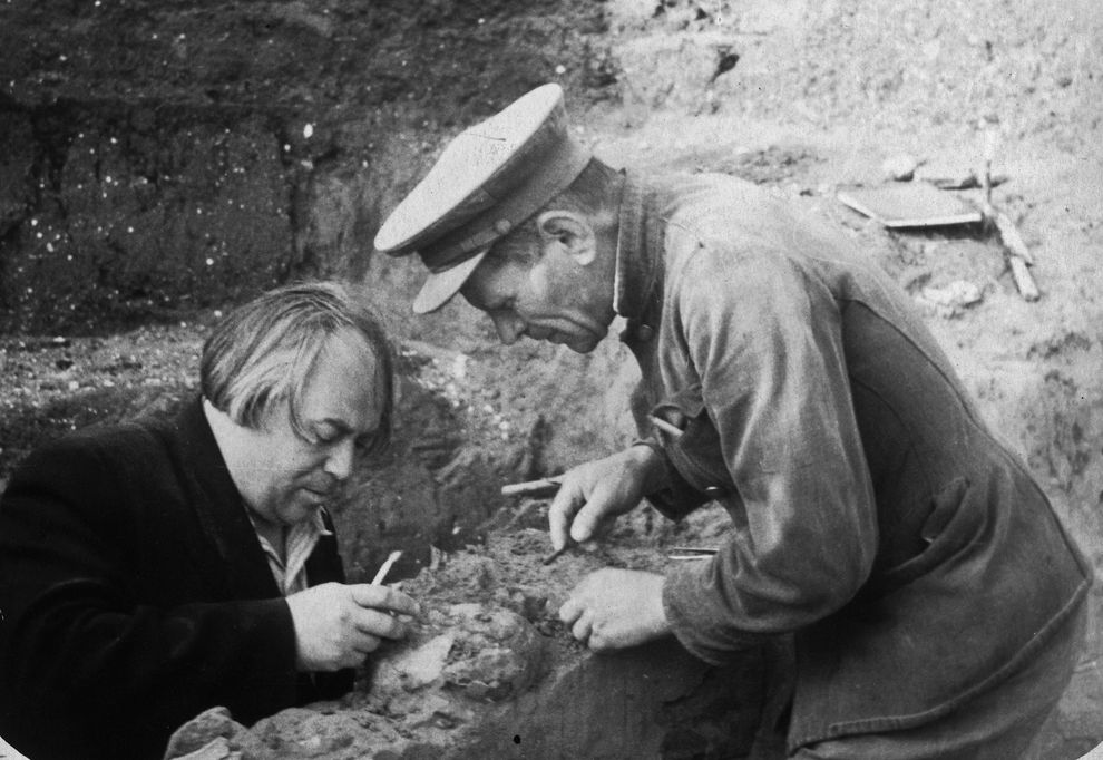 Photo of two men excavating the fossil.
