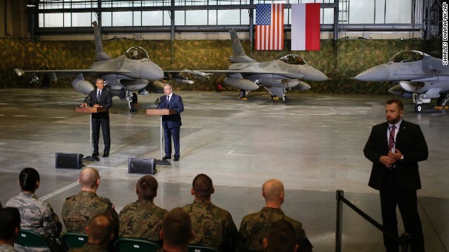 A Polish security official, right, stands watch as Obama and Komorowski make statements after meeting U.S. and Polish troops at an event in Warsaw on June 3. The main focus of Obama's Poland visit comes Wednesday, June 4, when he will give a speech 25 years after the nation's historic elections of 1989.
