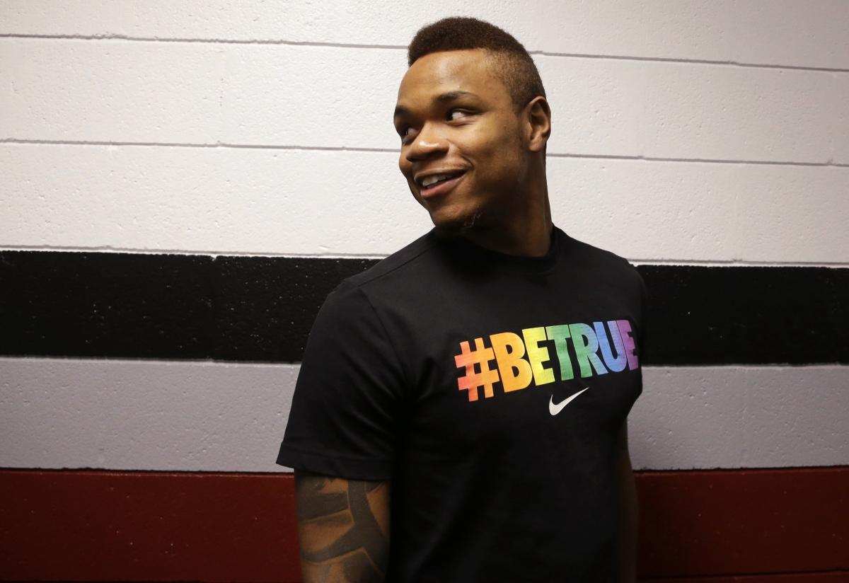 University of Massachusetts basketball guard Derrick Gordon, 22, enters a hallway before facing reporters on the school's campus, Wednesday, April 9, 2014, in Amherst, Mass. Gordon has become the first openly gay player in Division I men's basketball. (AP Photo/Steven Senne)