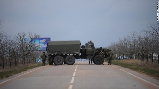 Russian troops block a road February 28 toward the military airport in Sevastopol, Ukraine, on the Black Sea coast. The Russian Black Sea Fleet is based at the port city of Sevastopol. Ukraine suspects Russia of fomenting tension in the autonomous region of Crimea, which might escalate into a bid for separation by its Russian majority.