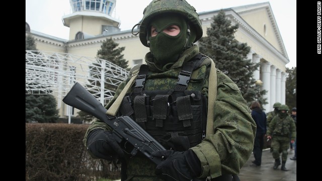 An armed man wearing no identifying military insignia patrols outside Simferopol International Airport on February 28. 