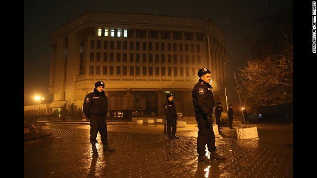 Police stand guard outside the Crimea regional parliament building in Simferopol on Thursday, February 27. Armed men seized the regional government administration building and parliament in Crimea. 
