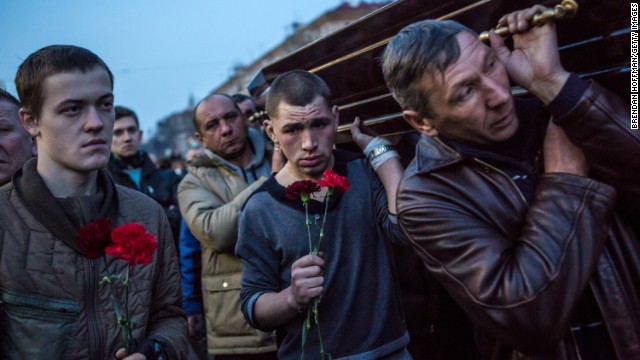 Men in Kiev carry a casket containing the body of a protester killed in clashes with police.