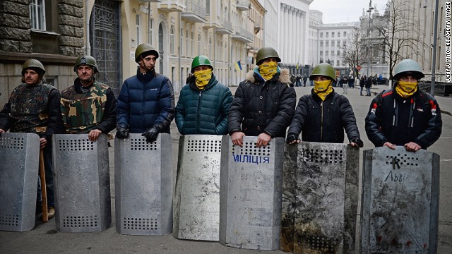 Anti-government protesters guard the streets next to the presidential offices in Kiev on February 22. 