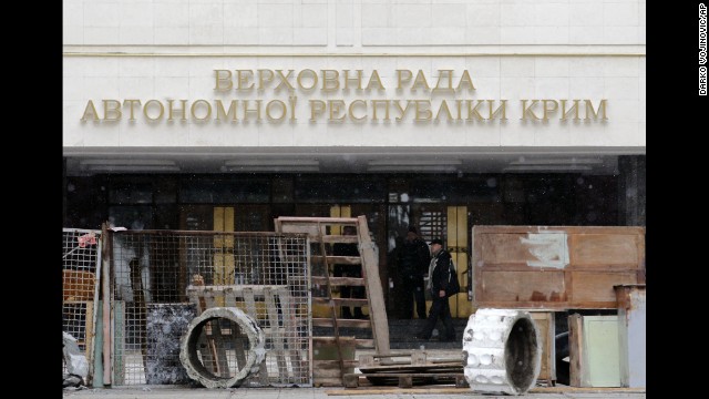 Protesters stand in front of a government building in Simferopol on February 27. Tensions have simmered in the Crimea region since the Ukrainian president's ouster.