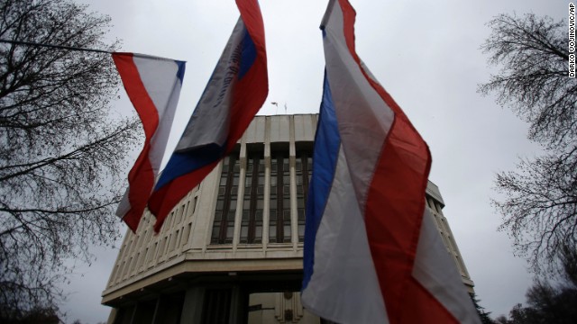 Pro-Russia demonstrators wave Russian and Crimean flags in front of a local government building in Simferopol on February 27. 