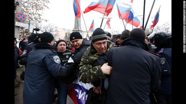 Police intervene as Russian supporters gather in front of the parliament building in Simferopol on February 27.