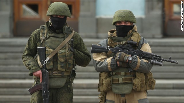 Heavily armed troops, displaying no identifying insignia and who were mingling with local pro-Russian militants, stand guard outside a local government building in Simferopol, Ukraine, on March 2. 