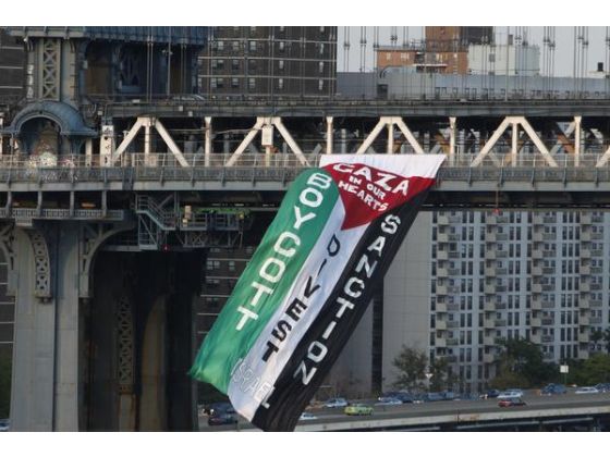 Demonstrators hang a protest flag from the south side of New York's Manhattan Bridge during a pro-Palestinian rally, Aug. 20.