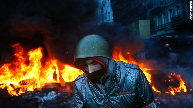 A protester walks past burning tires in Kiev on January 23.