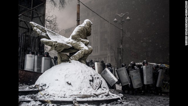 Riot police officers line up in Kiev during clashes on Wednesday, January 22.