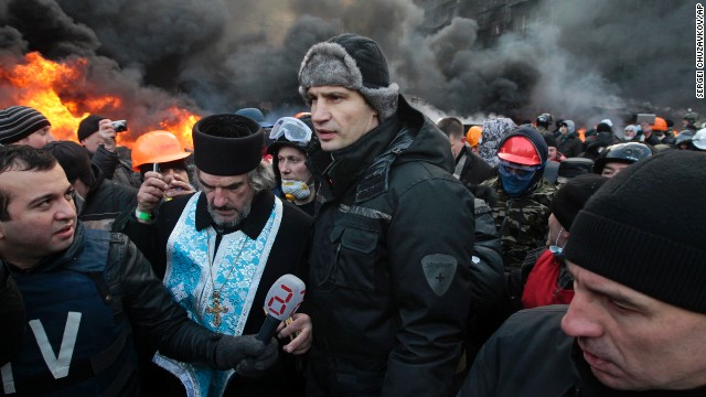 Opposition leader Vitali Klitschko, center, addresses protesters near the burning barricades between police and protesters in central Kiev on January 23.