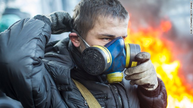 A protester puts on a gas mask near Dynamo Stadium in Kiev on January 24.