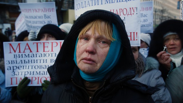 Ukrainian Oksana Tikhomirova cries as she urges riot police to stop the violence outside a government district in central Kiev on January 24.