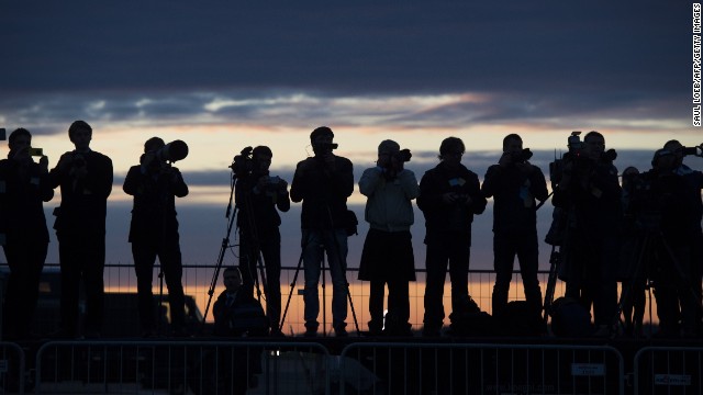 Estonian press photographers cover Obama's arrival at Tallinn Airport early on September 3.