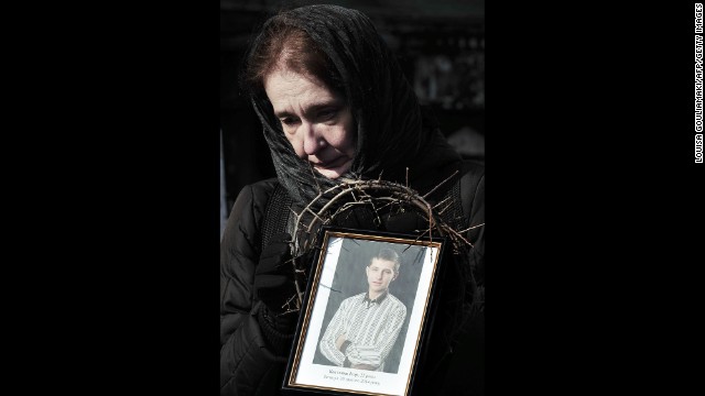 A woman holds a photograph of a protester killed during the height of tensions on February 26 in Kiev.